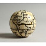 A BONE FOLDING POCKET GLOBE/COMPASS. 7cms diameter.