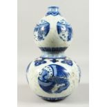 A BLUE AND WHITE DOUBLE GOURD PORCELAIN VASE, painted with exotic birds. 30cms high.