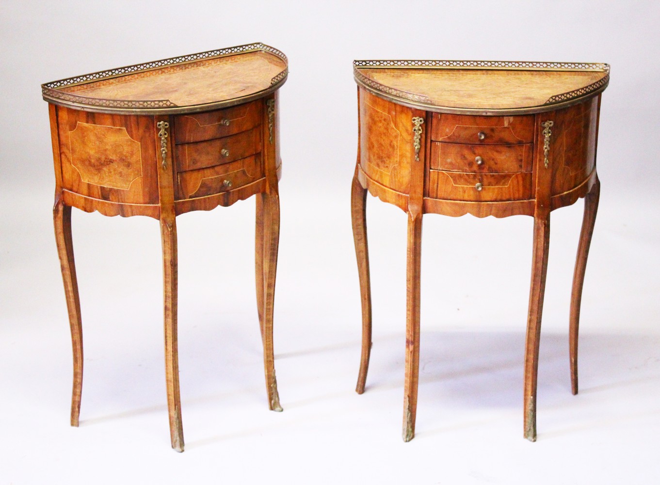 A PAIR OF FRENCH STYLE WALNUT THREE DRAWER BOWFRONT PETIT COMMODE, 20TH CENTURY, on cabriole legs.