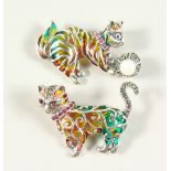 TWO NOVELTY SILVER AND ENAMEL CAT BROOCHES with rubies and pearls.