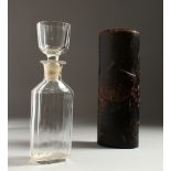 AN UNUSUAL 19TH CENTURY GLASS FLASK, the stopper also forming a cup, in a leather case. 21cms high.