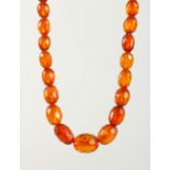 A SET OF FACETED AMBER BEADS. Largest: 18mm long. Overall Length: 88cms.