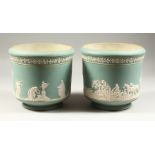 A PAIR OF ADAMS PALE GREEN JASPERWARE STONEWARE CIRCULAR JARDINIERES, one with hunting scenes, the