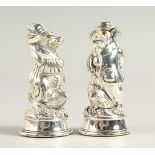 A PAIR OF .800 SILVER FOX IN A DRESS SALT AND PEPPERS.