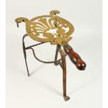 A 19TH CENTURY BRASS AND WROUGHT IRON TRIVET, with turned wood handle. 32cms high.