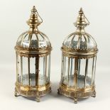 A PAIR OF DECORATIVE LANTERNS, with silvered patination. 60cms high.