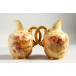 TWO SMALL ROYAL WORCESTER JUGS, Pattern No. 1094, with gilt handles, the borders painted with
