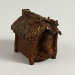 A SMALL BRONZE MODEL OF A HOUSE. 6cms wide.