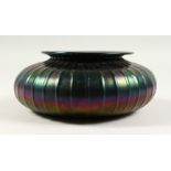 A LOETZ TYPE CIRCULAR IRIDESCENT BOWL with ribbed decoration. 21cms diameter.