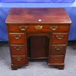 A GEORGE III MAHOGANY KNEEHOLE DESK, with a single frieze drawer, central cupboard flanked by