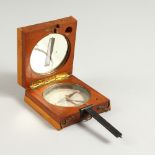 A 19TH CENTURY FRENCH MAHOGANY AND BOXWOOD FOLDING COMPASS. 9cms wide (closed).