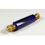 A VICTORIAN CUT BRISTOL BLUE FACET CUT DOUBLE ENDED SCENT BOTTLE with plated gilt tops. 13.5cms