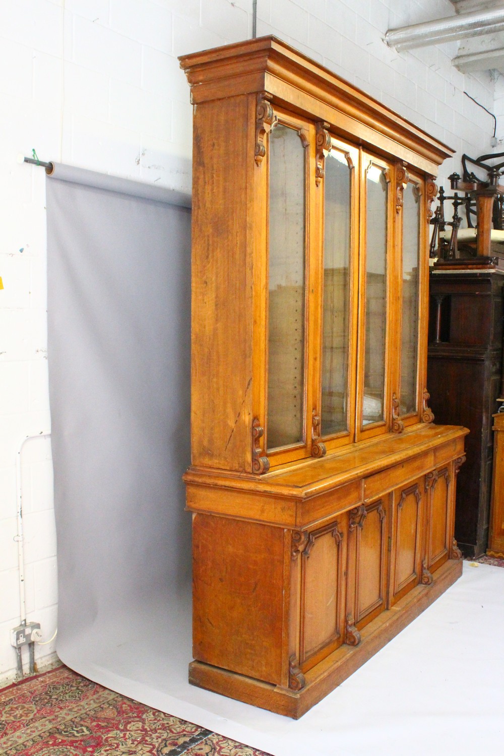 A VICTORIAN OAK LIBRARY BOOKCASE, with a moulded cornice above four glazed doors enclosing - Image 3 of 17