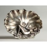 A SMALL SILVER PLATED CAST METAL DISH, modelled as a lady lying on a lily pad. 12.5cms wide.