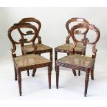 A SET OF FOUR REGENCY ROSEWOOD DINING CHAIRS, with carved hoop backs, cane work seats, on turned,