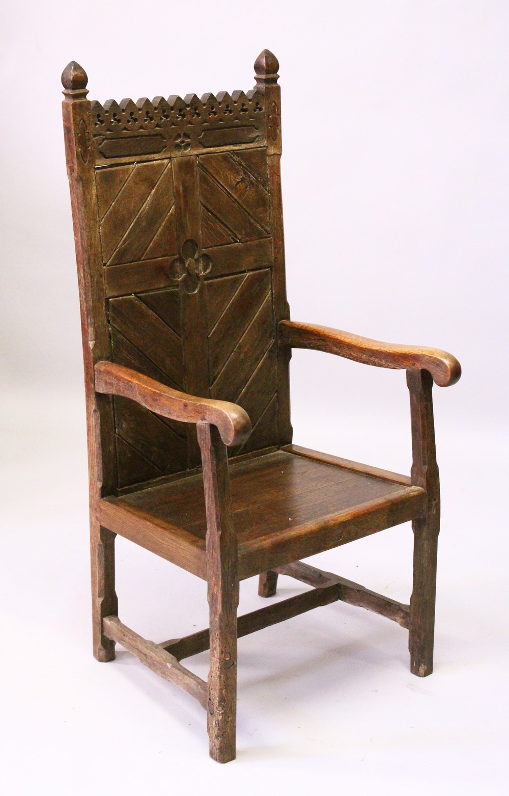 AN 18TH CENTURY AND LATER OAK GOTHIC ARMCHAIR, with pierced and carved cresting, tongue and groove