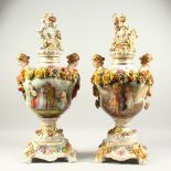 A GOOD PAIR OF MEISSEN DESIGN FLOWER AND FRUIT VASES, COVERS AND STANDS, the covers with cupids