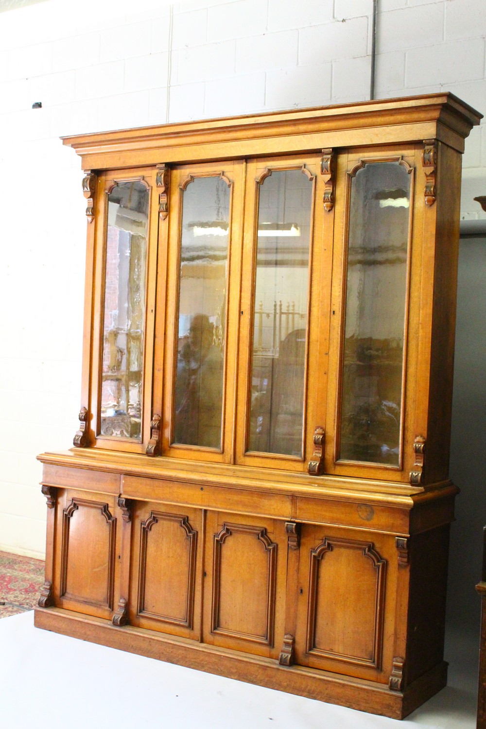 A VICTORIAN OAK LIBRARY BOOKCASE, with a moulded cornice above four glazed doors enclosing - Image 15 of 17