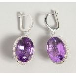 A GOOD PAIR OF SILVER AND AMETHYST OVAL EARRINGS.