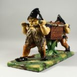 A LARGE MAJOLICA BASKET with two gnomes carrying a basket. 19ins long.