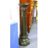 A SERPENTINE COLUMN, with a circular top and column, on an octagonal shaped base. 28cms diameter x