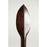A CARVED WOOD PADDLE CLUB, possibly Pacific Island, with a spear shaped point to each end. 98cms