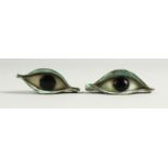 A PAIR OF EGYPTIAN STYLE COPPER AND PLASTER MODELS OF EYES. 7cms wide.