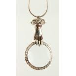 A SILVER MAGNIFYING GLASS on a chain.