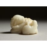 A SMALL WHITE JADE CARVING OF A RAM. 4cms long.