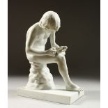 A PARIAN WARE GROUP, young boy picking a thorn from his foot. 28cms high.