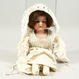 ARMAND MARSEILLE, A2M A BISQUE HEADED DOLL, with cloth body. 1ft 5ins long.