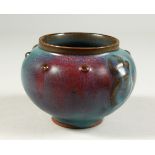 A PURPLE SPLASH TURQUOISE POTTERY BOWL. 13cms diameter.