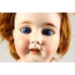 MON TRESOR (1914-1916) FRENCH A RARE BISQUE HEADED YOUNG GIRL DOLL, with blue eyes, long curly hair,