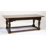 AN 18TH CENTURY STYLE OAK REFECTORY TABLE, with cleated five plank top, turned legs united by
