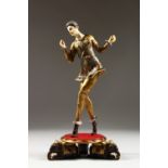 AN ART DECO GILDED DANCING FIGURE, with ivory head and hands, on a circular base with elephants.