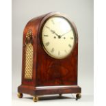 A REGENCY MAHOGANY BRACKET CLOCK, with domed top, brass grilled sides, lion ring handle, eight-day