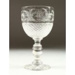A SUPERB ETCHED GOBLET, with crests and dated 1877, the stem with a silver penny also dated 1877.
