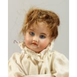 A BISQUE HEADED BABY DOLL, with articulated body. 10ins long.