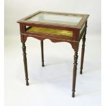 AN EDWARDIAN MAHOGANY BIJOUTERIE TABLE, with glazed rising top and sides, on turned legs. 61cms wide