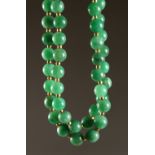 A LONG COLOURED JADE NECKLACE. 3ft 10ins long.