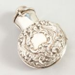 A GOOD VICTORIAN CIRCULAR GLASS SCENT BOTTLE AND STOPPER in a folding silver case repousse with