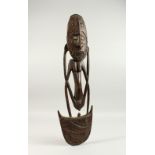 A SEPTIC RIVER / NEW GUINES CARVED WOOD FOOD HOOK, carved as a female figure with a crocodile to the