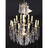 A GOOD CUT GLASS AND SILVERED METAL TWO-TIER CHANDELIER, comprising fifteen scrolling arms, each