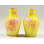 A SUPERB PAIR OF THREE-COLOUR CAMEO GLASS VASES, with leaves and flowers. 5.5ins high.