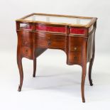 A FRENCH MAHOGANY BIJOUTERIE TABLE, EARLY 20TH CENTURY, of serpentine outline, rising glass top,