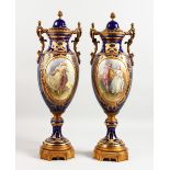 A SUPERB PAIR OF 19TH CENTURY SEVRES VASES AND COVERS, painted with reverse panels of a gallant