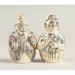 A PAIR OF .800 SILVER MR & MRS PUNCH SALT AND PEPPERS.