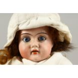 ALICE, No. 121 A SMALL BISQUE HEADED DOLL, with long hair and articulated body. 1ft 4ins long.