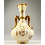 A ROYAL WORCESTER TWO-HANDLED BLUSH IVORY BULBOUS VASE, Pattern No. 1532, with gilt handles, the