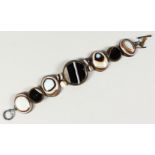 A BANDED AGATE BRACELET, comprising seven plaques and four spheres. 19cms long.